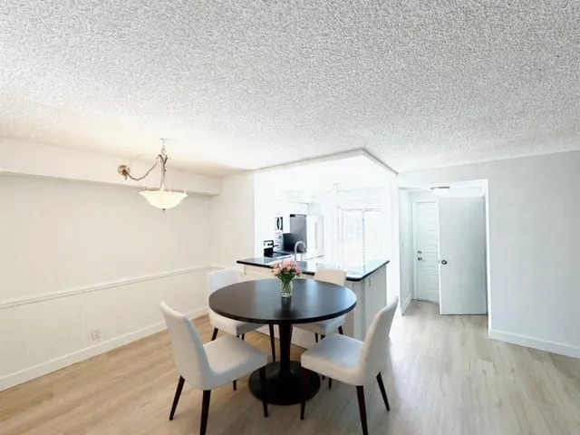 a dining room with furniture and wooden floor