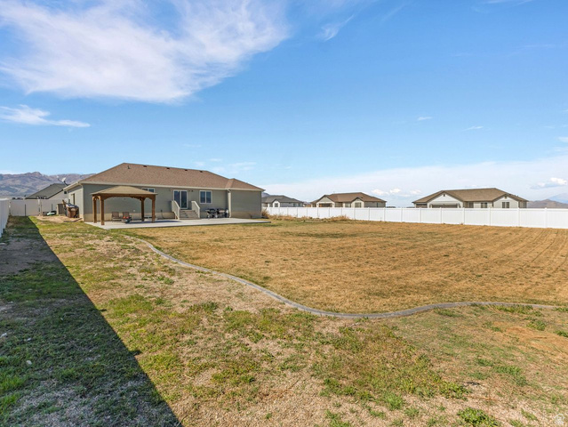 573 South Maxwell Drive Grantsville, UT 84029 - Photo 23 of 25 Fenced backyard featuring a patio and a mountain view