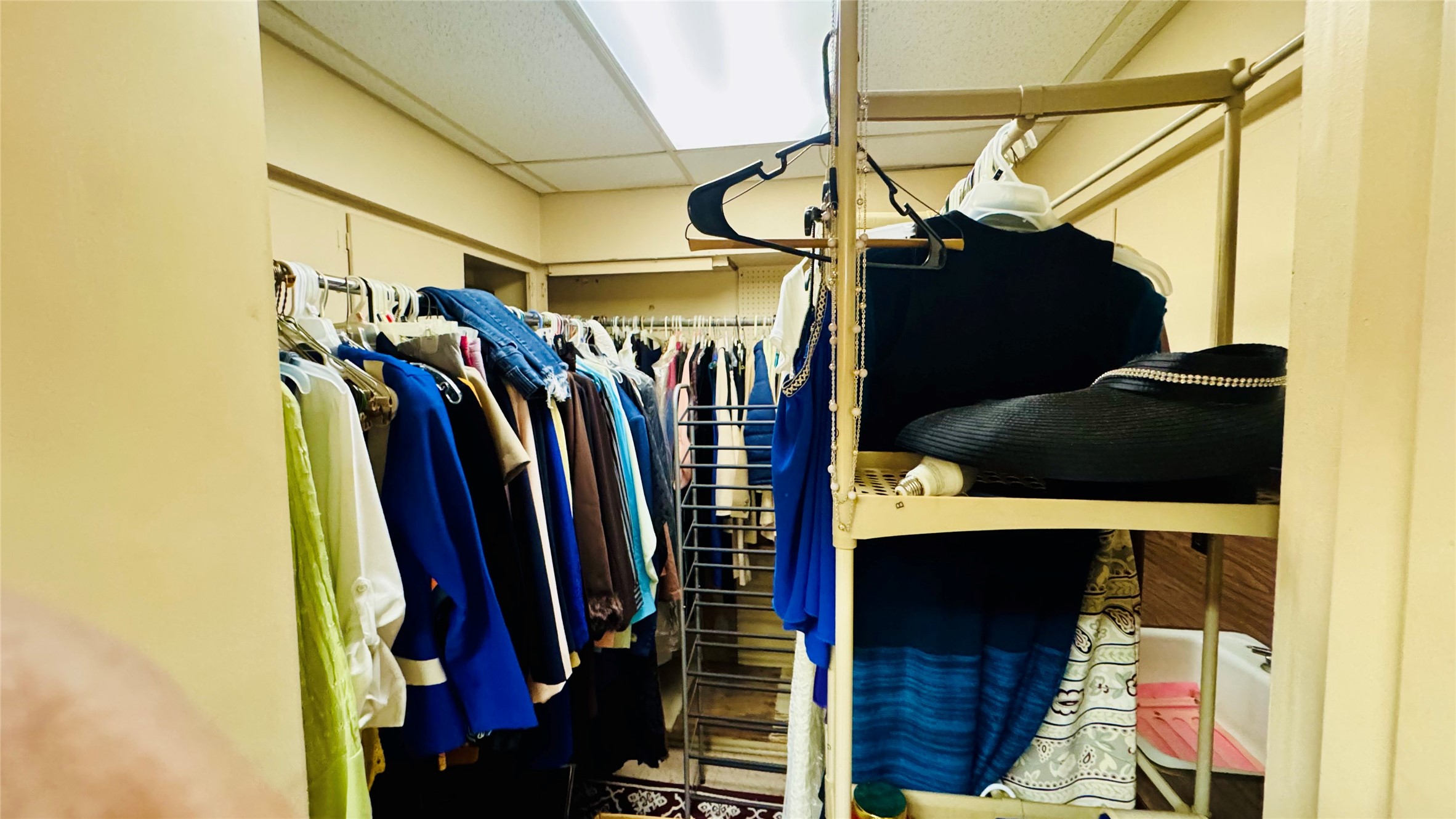 811 North Travis Street Liberty, TX 77575 - Photo 18 of 31 a view of walk in closet with clothes and shoes
