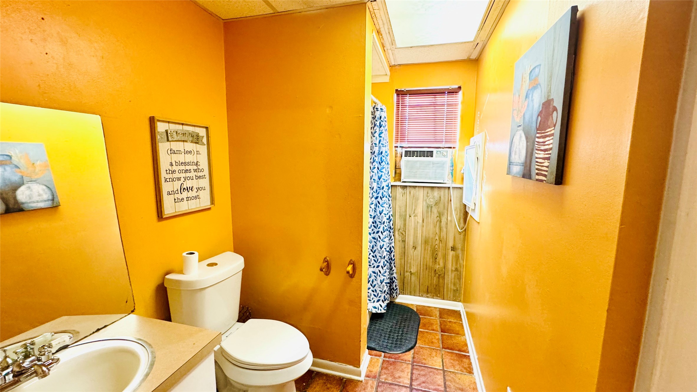 811 North Travis Street Liberty, TX 77575 - Photo 7 of 31 a white toilet sitting next to a bathroom sink
