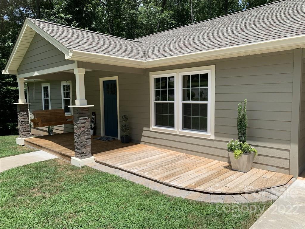 a view of house with backyard porch and sitting area