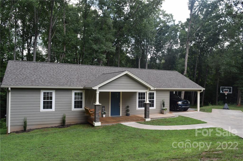 162 Gold Run Rutherfordton, NC 28139 - Photo 2 of 26 a front view of a house with a yard porch and outdoor seating