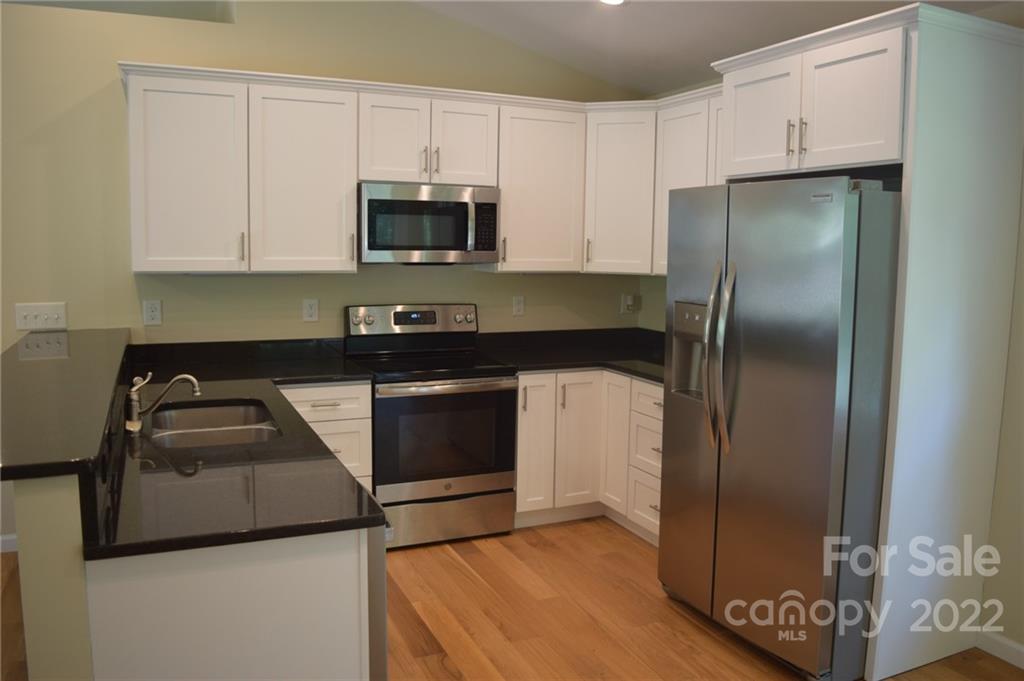 162 Gold Run Rutherfordton, NC 28139 - Photo 4 of 26 a kitchen with a refrigerator sink and cabinets