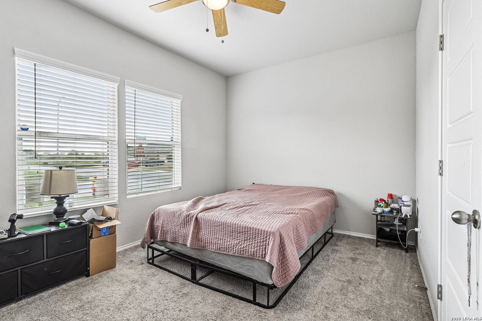 20045 Huckleberry Street Lytle, TX 78052 - Photo 19 of 39 a bedroom with a bed and a chandelier