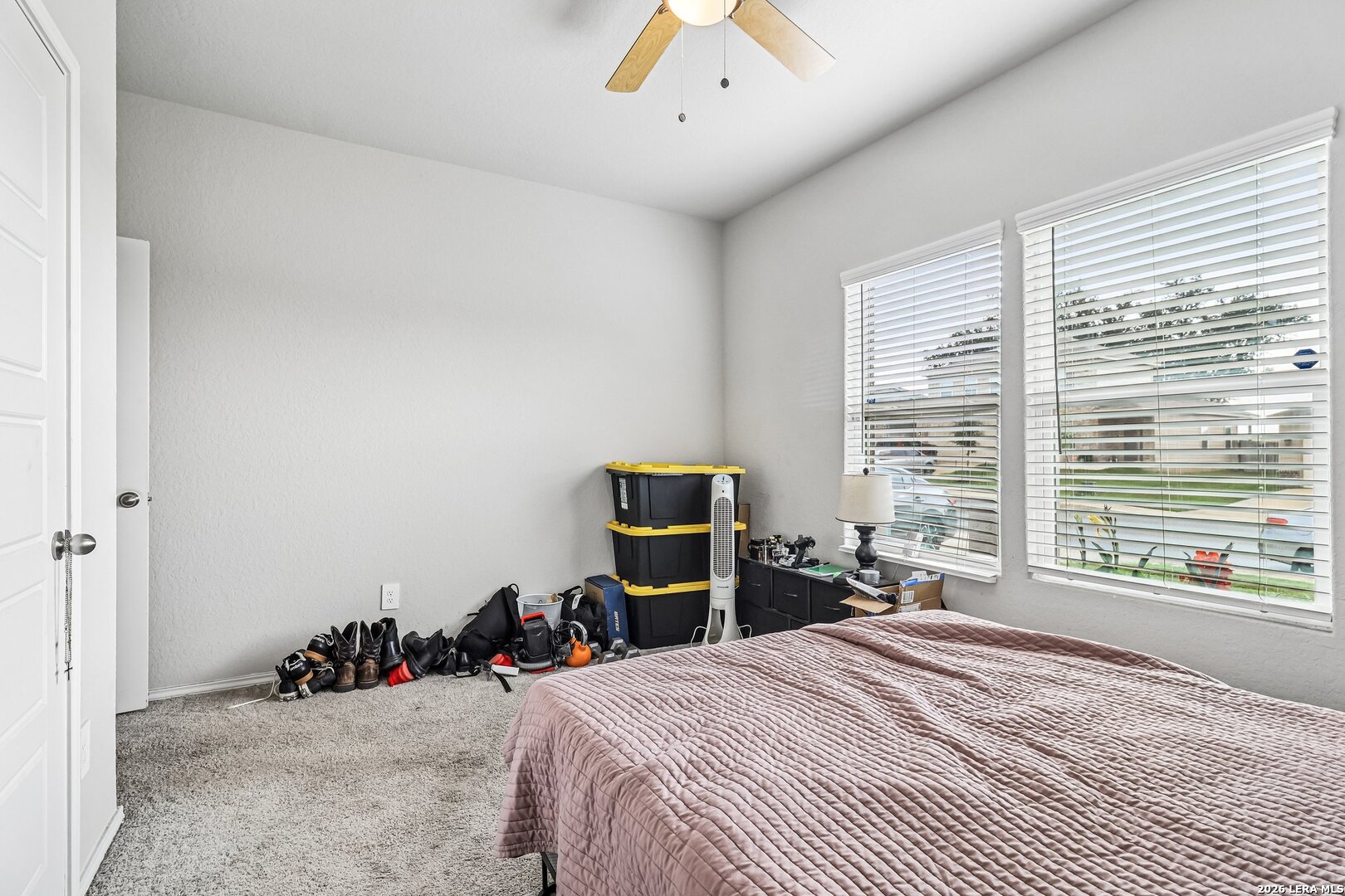 20045 Huckleberry Street Lytle, TX 78052 - Photo 20 of 39 a bedroom with a bed and a large window