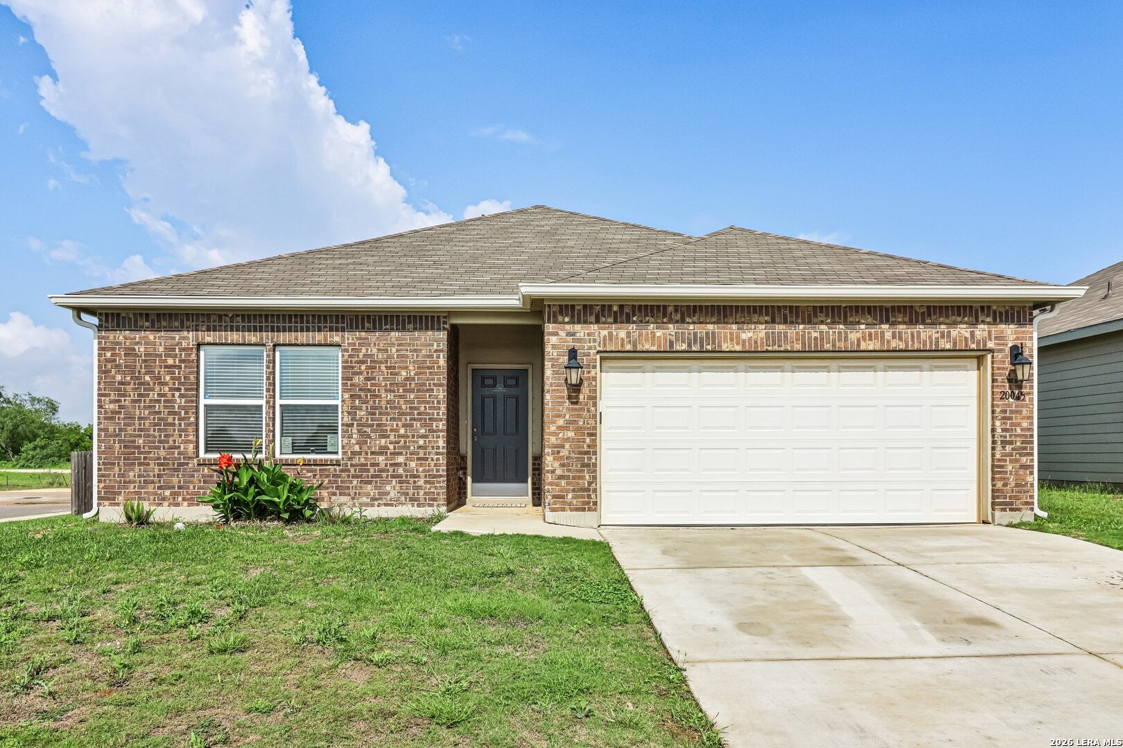 20045 Huckleberry Street Lytle, TX 78052 - Photo 2 of 39 a front view of a house with garden