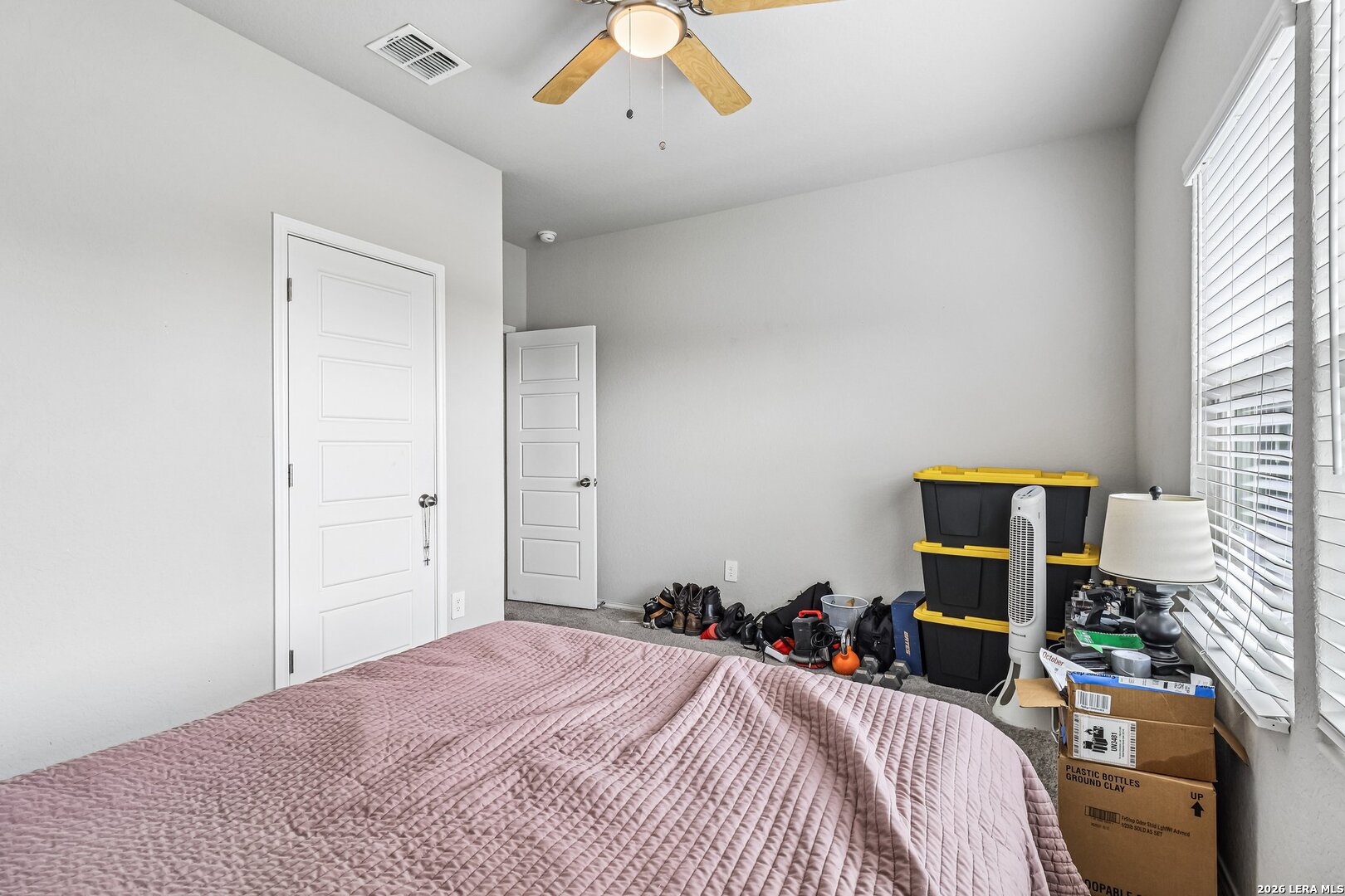 20045 Huckleberry Street Lytle, TX 78052 - Photo 21 of 39 a bedroom with a bed and a chandelier