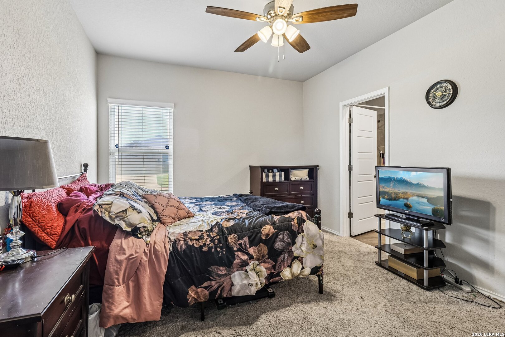 20045 Huckleberry Street Lytle, TX 78052 - Photo 23 of 39 a bedroom with a bed and a chandelier