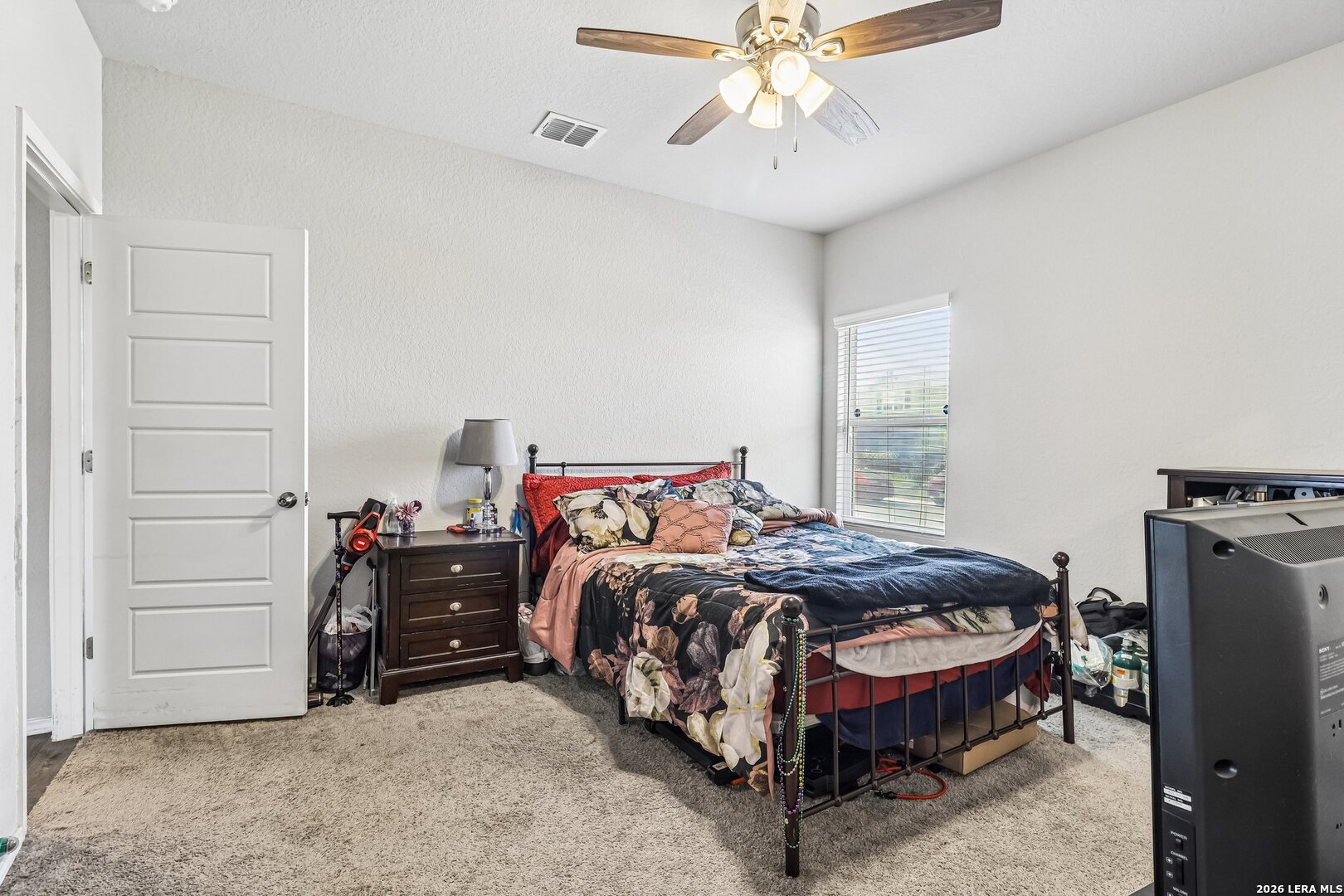 20045 Huckleberry Street Lytle, TX 78052 - Photo 24 of 39 a bedroom with a bed and a chandelier