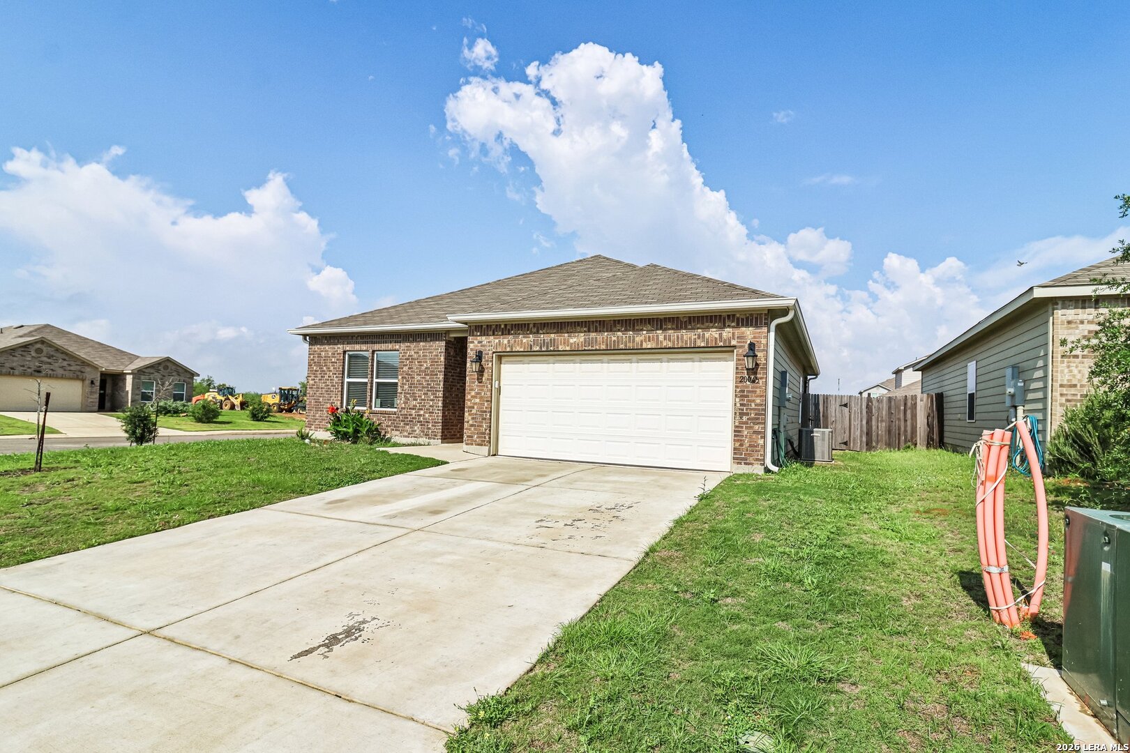 20045 Huckleberry Street Lytle, TX 78052 - Photo 5 of 39 a front view of a house with garden