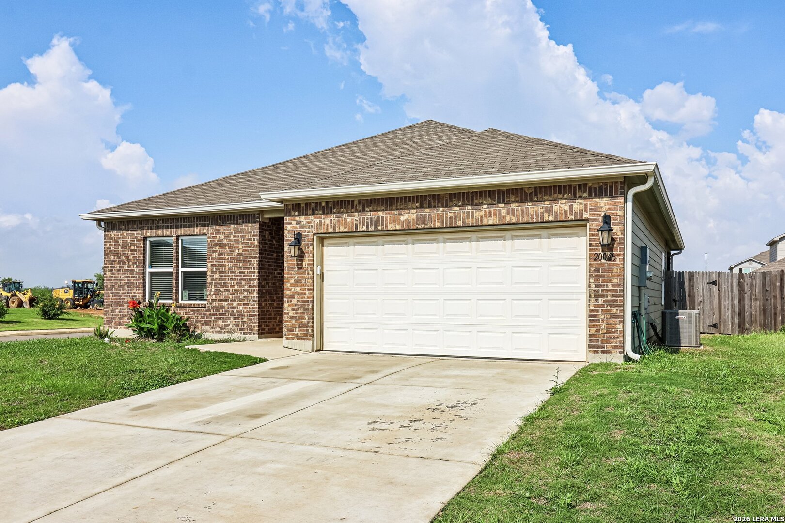 20045 Huckleberry Street Lytle, TX 78052 - Photo 6 of 39 a front view of a house with a garden