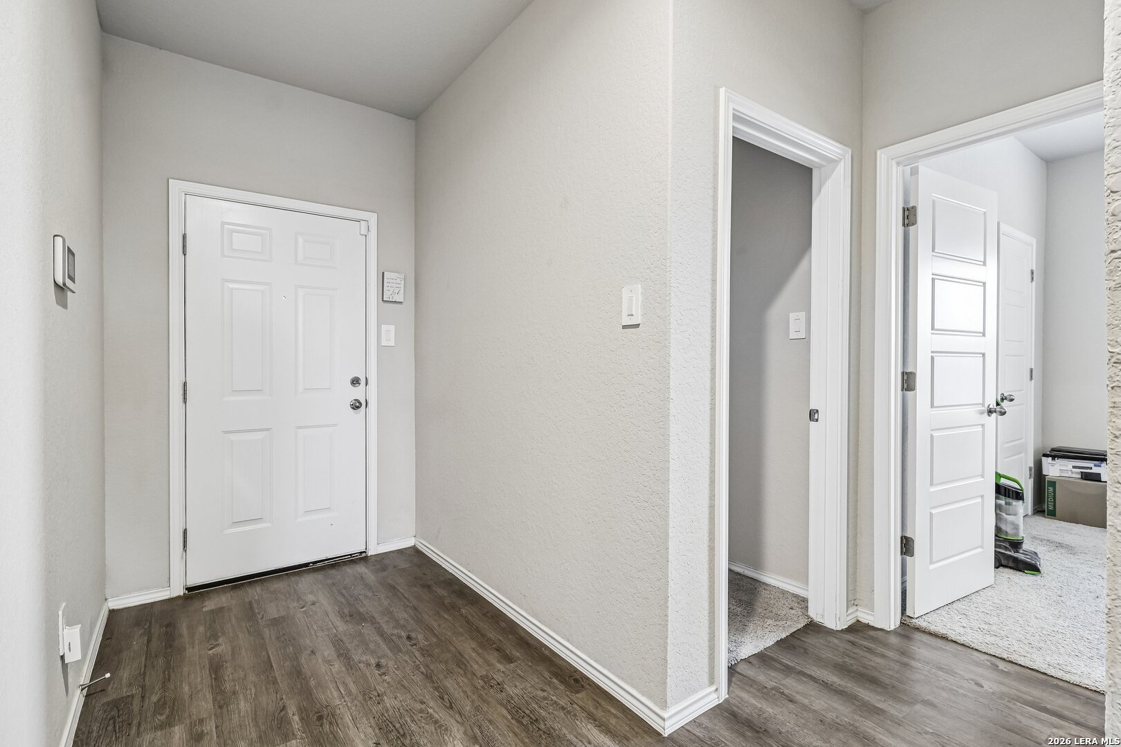 20045 Huckleberry Street Lytle, TX 78052 - Photo 8 of 39 a view of a hallway with wooden floor and closet area