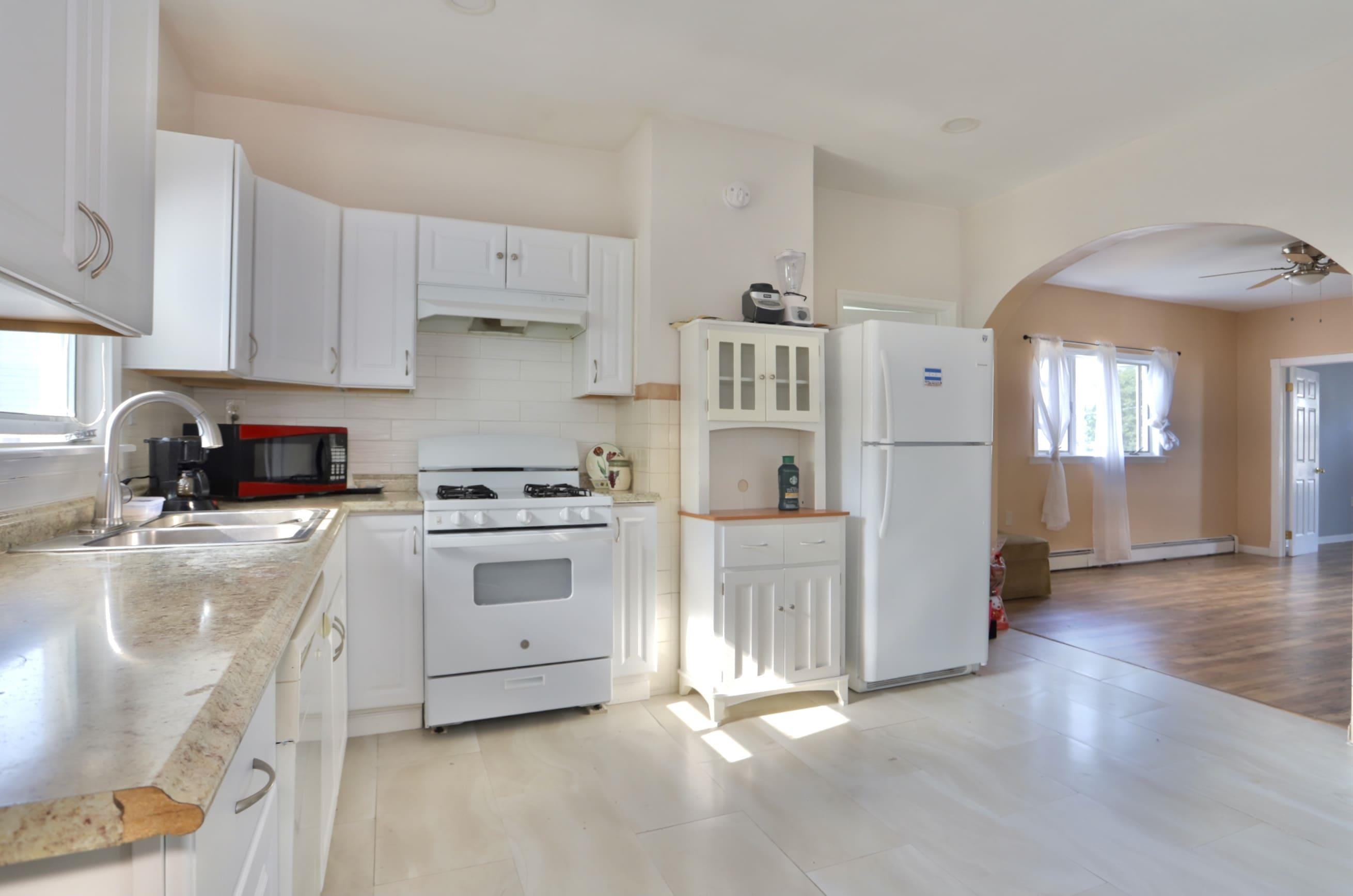 a kitchen with stainless steel appliances a stove a sink and a refrigerator