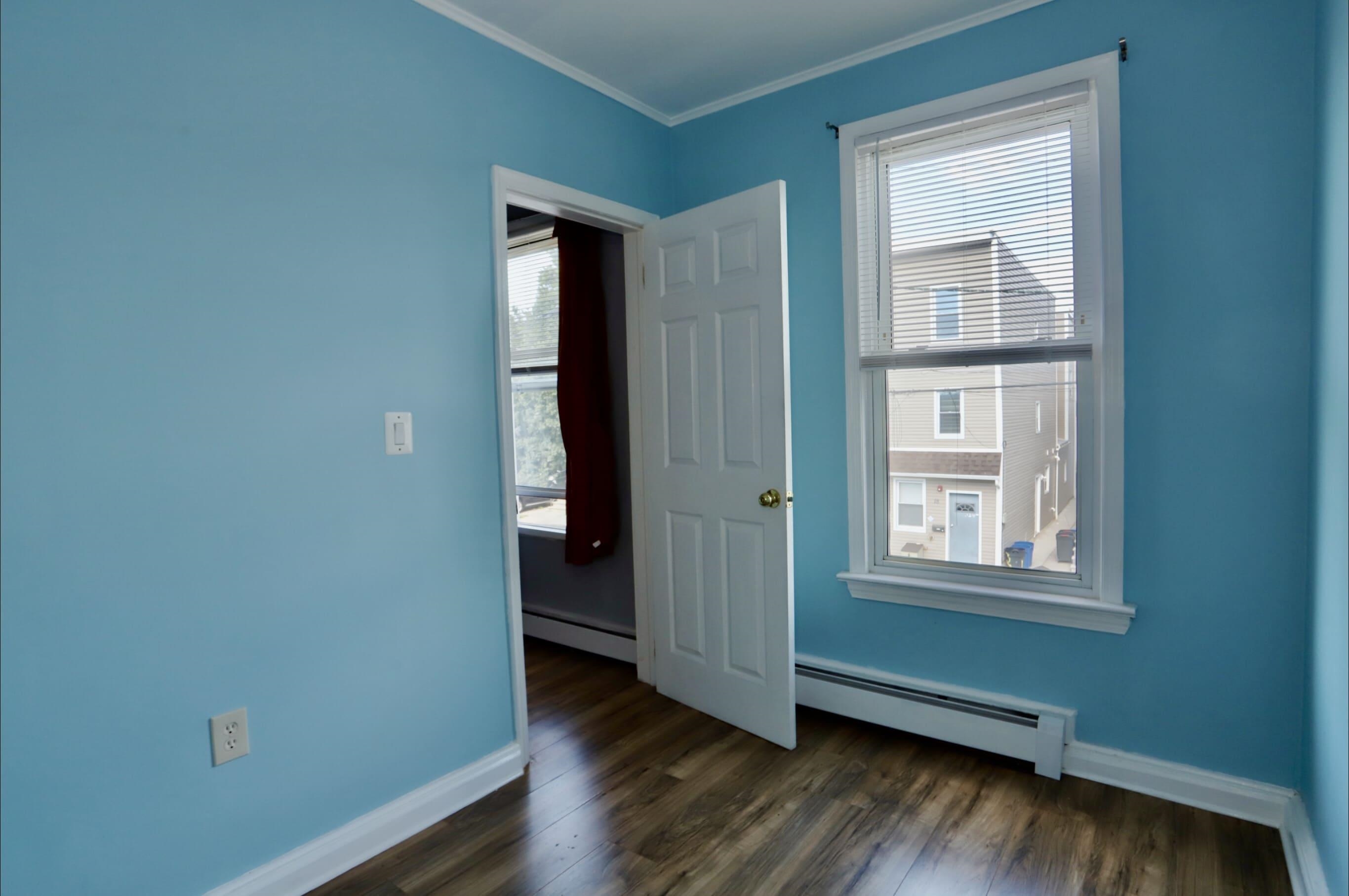 17 Grant Avenue, Unit 2 Harrison, NJ 07029 - Photo 14 of 17 an empty room with wooden floor and windows