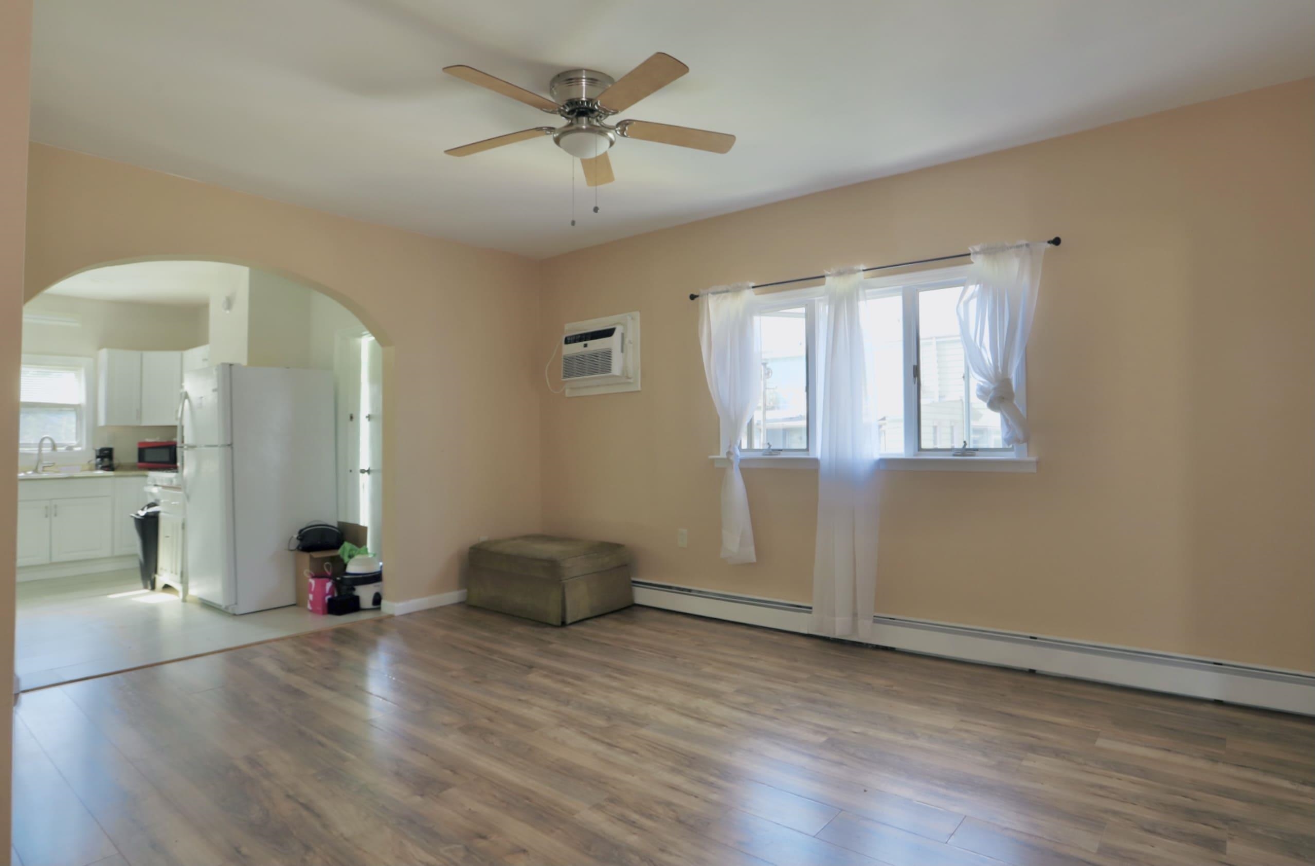 17 Grant Avenue, Unit 2 Harrison, NJ 07029 - Photo 4 of 17 an empty room with wooden floor and windows