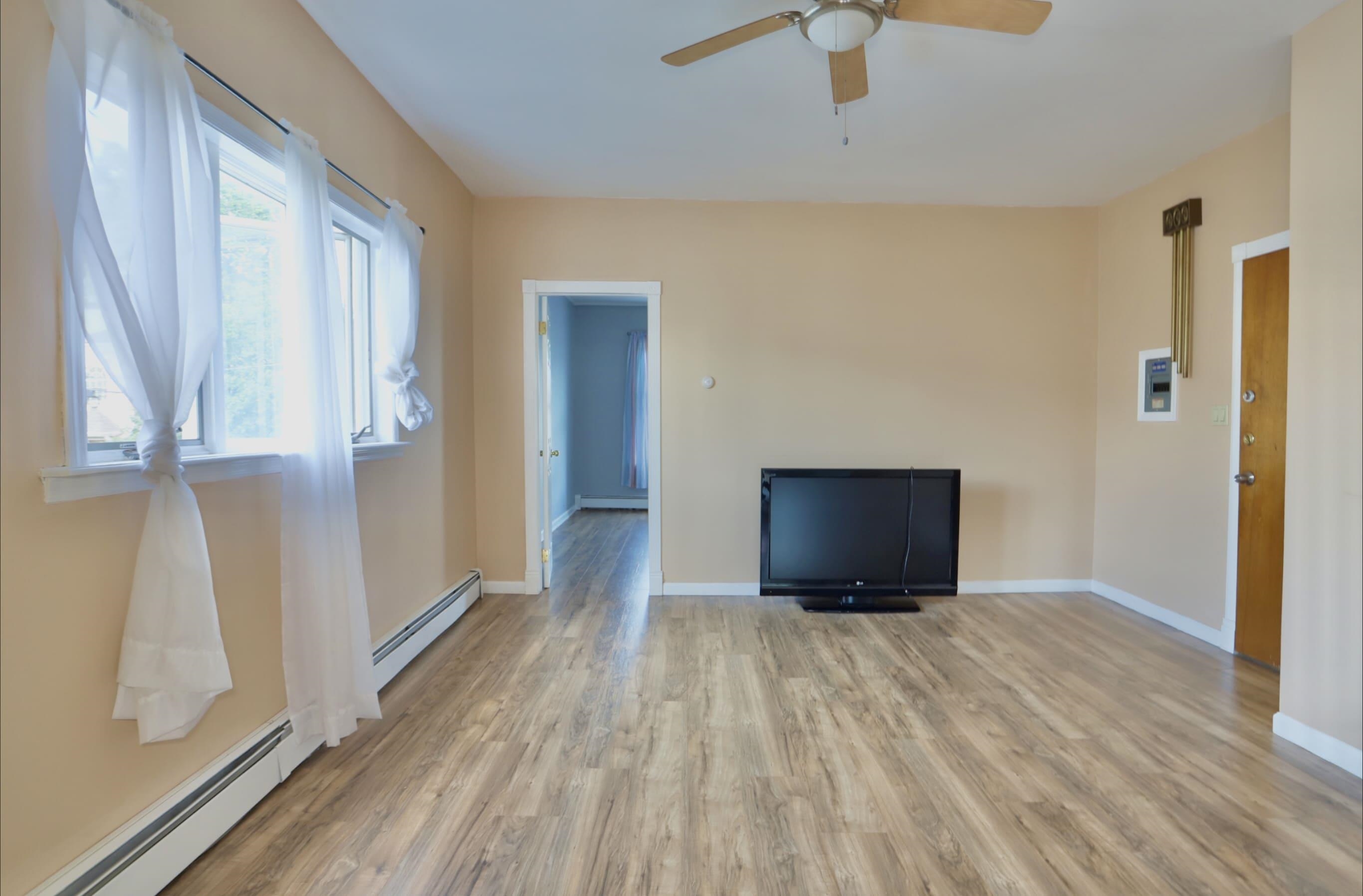 17 Grant Avenue, Unit 2 Harrison, NJ 07029 - Photo 6 of 17 a view of an empty room with wooden floor and a window