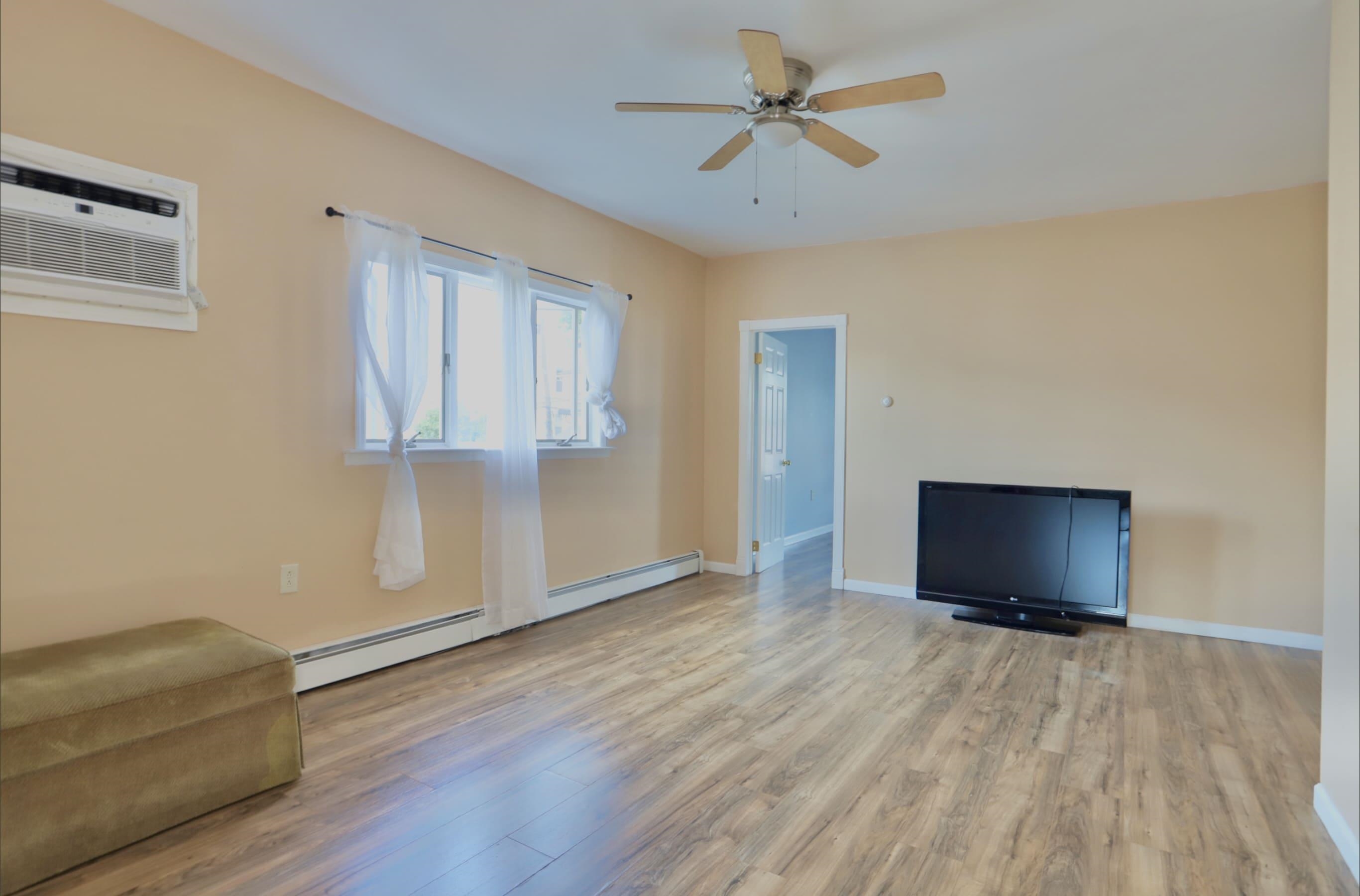 17 Grant Avenue, Unit 2 Harrison, NJ 07029 - Photo 7 of 17 wooden floor in an empty room with a window