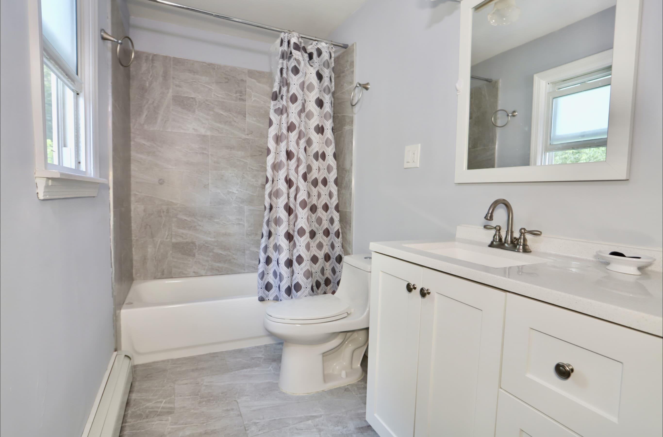 17 Grant Avenue, Unit 2 Harrison, NJ 07029 - Photo 8 of 17 a bathroom with a sink toilet and shower