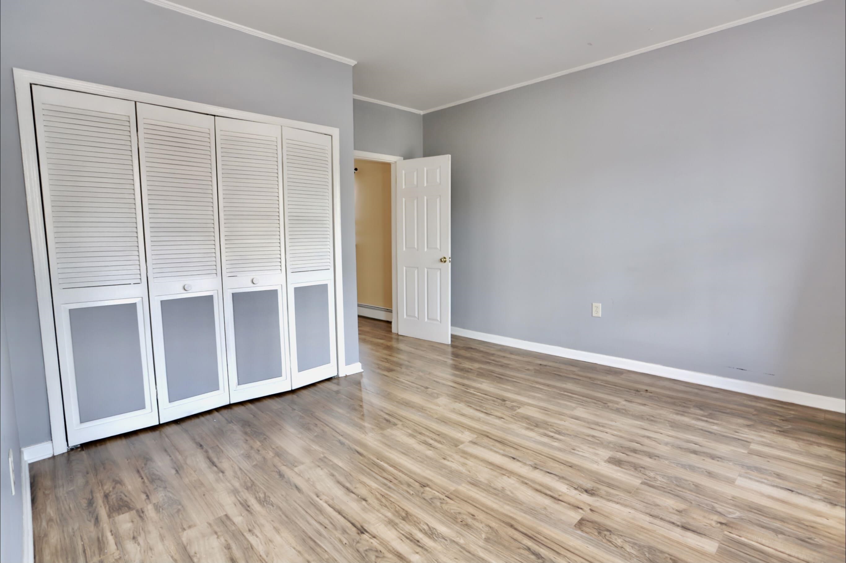 17 Grant Avenue, Unit 2 Harrison, NJ 07029 - Photo 10 of 17 an empty room with wooden floor and sliding door