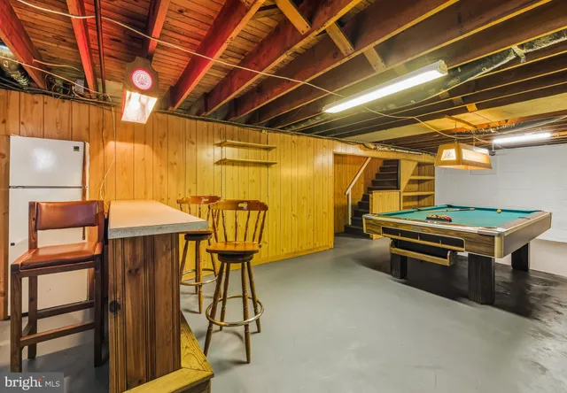 a roof deck with table and chairs