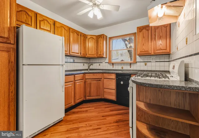 a kitchen with stainless steel appliances granite countertop a refrigerator sink and cabinets