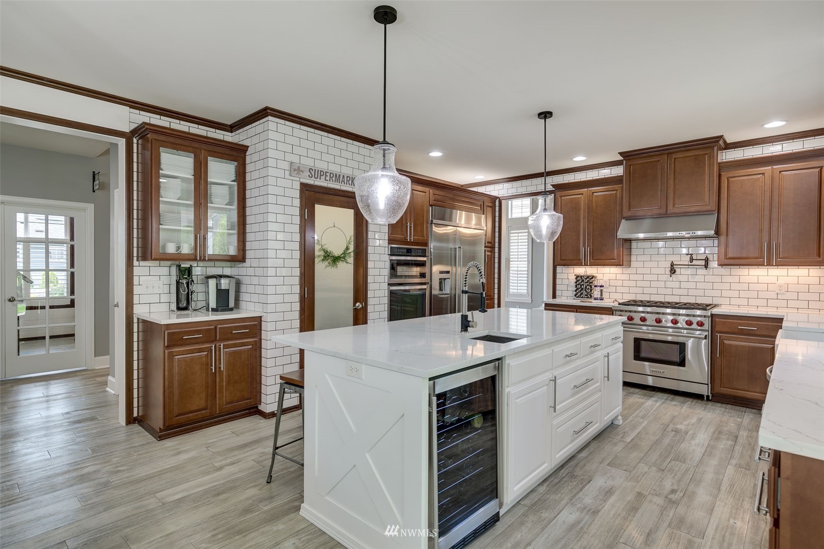 4426 221st Street Southeast Bothell, WA 98021 - Photo 15 of 40 a kitchen with white cabinets and stainless steel appliances
