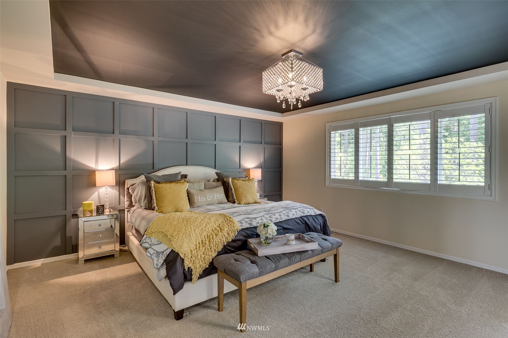 4426 221st Street Southeast Bothell, WA 98021 - Photo 23 of 40 a bedroom with a bed and a chandelier