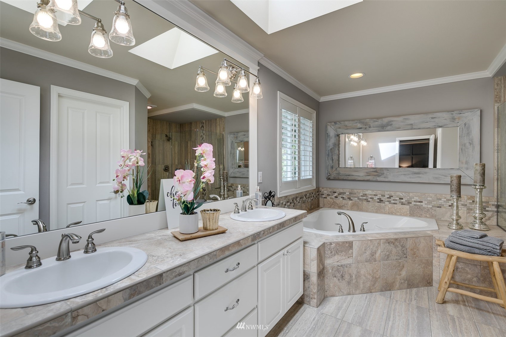 4426 221st Street Southeast Bothell, WA 98021 - Photo 25 of 40 a bathroom with double vanity sinks a vanity a lamp and a mirror