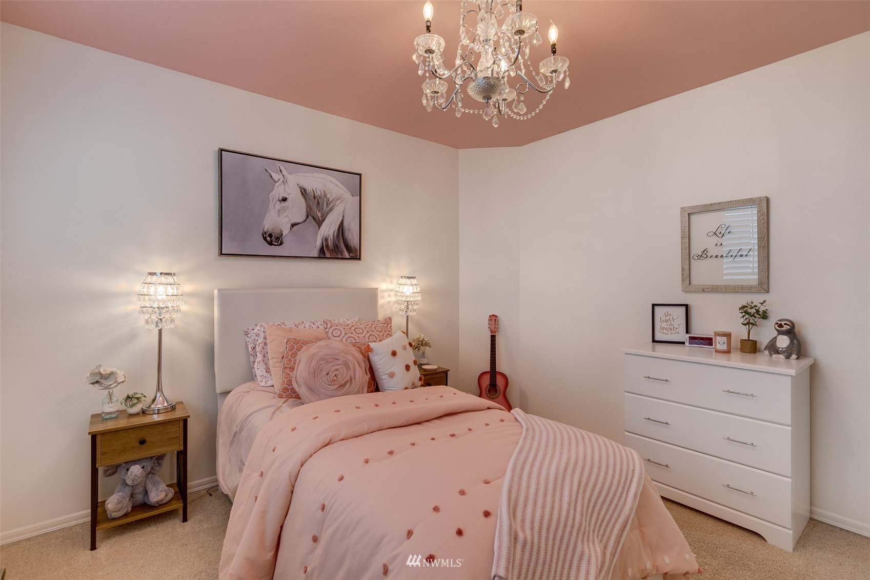 4426 221st Street Southeast Bothell, WA 98021 - Photo 29 of 40 a bedroom with a bed and a chandelier