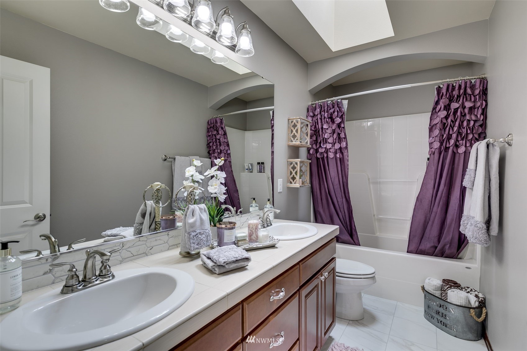4426 221st Street Southeast Bothell, WA 98021 - Photo 31 of 40 a bathroom with a sink a toilet and a mirror