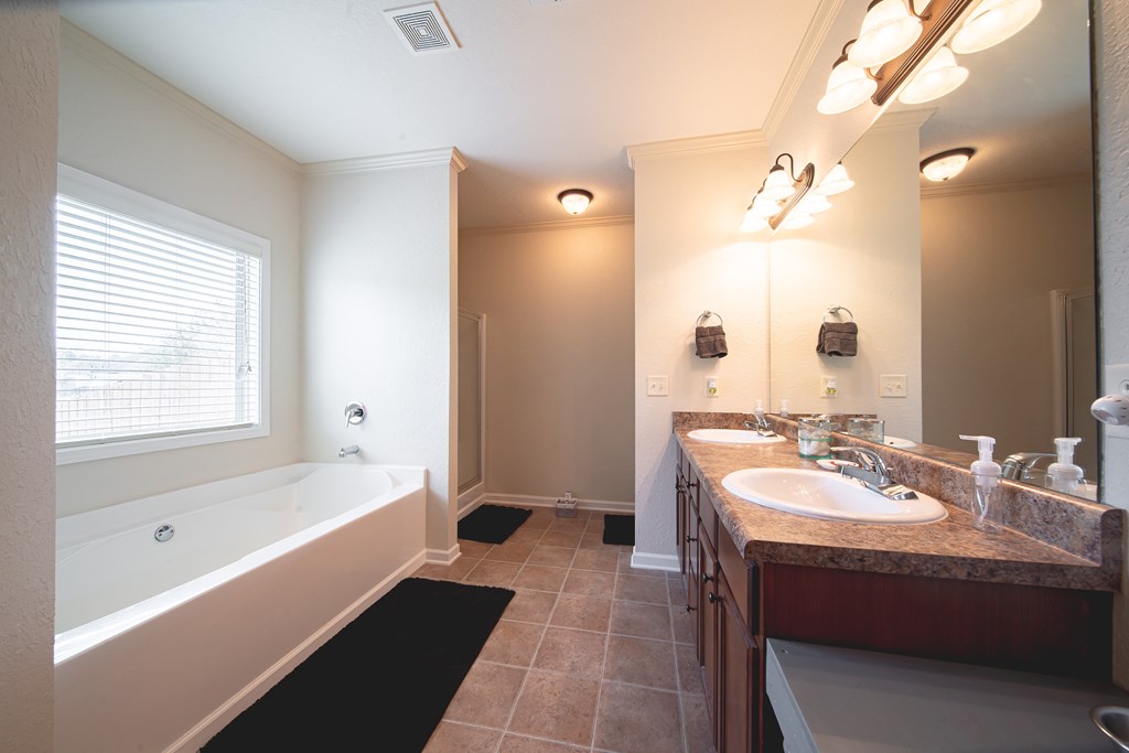 305 Owens Road Fort Mitchell, AL 36856 - Photo 20 of 44 a bathroom with a tub sink and mirror