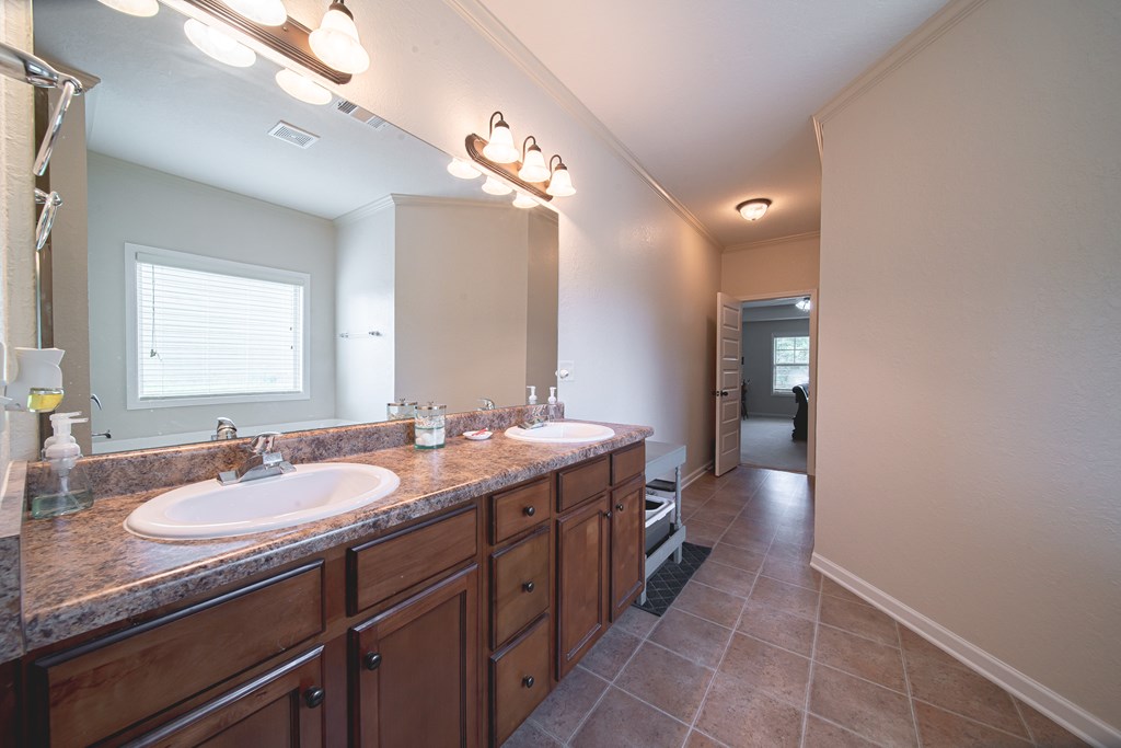 305 Owens Road Fort Mitchell, AL 36856 - Photo 24 of 44 a spacious bathroom with a granite countertop sink and a mirror