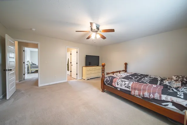 a room with a bed and a chandelier