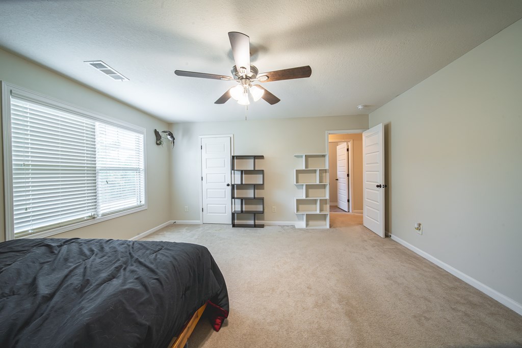 305 Owens Road Fort Mitchell, AL 36856 - Photo 37 of 44 a view of a bedroom with furniture and a ceiling fan