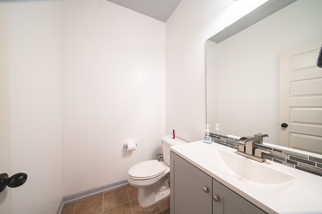 305 Owens Road Fort Mitchell, AL 36856 - Photo 7 of 44 a bathroom with a toilet a sink and mirror