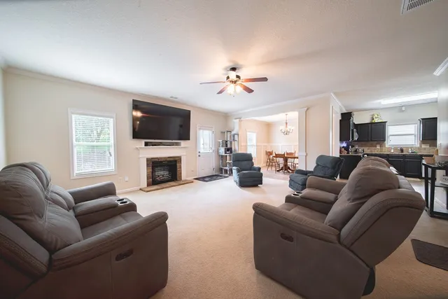 a living room with furniture and a fireplace
