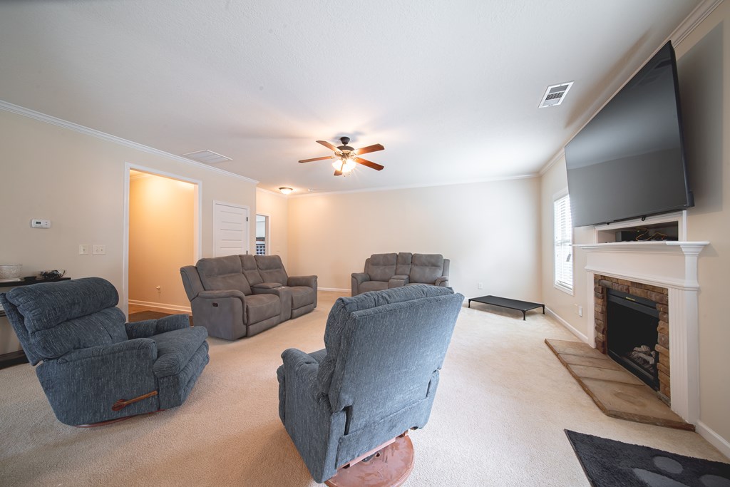 305 Owens Road Fort Mitchell, AL 36856 - Photo 9 of 44 a living room with furniture and a fireplace