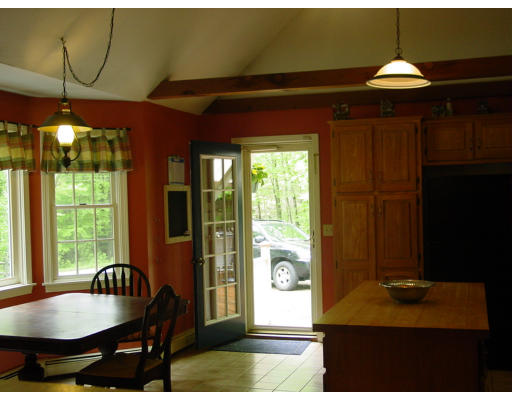 75 North Wales Road Holland, MA 01521 - Photo 10 of 10 a kitchen with a table and a chandelier