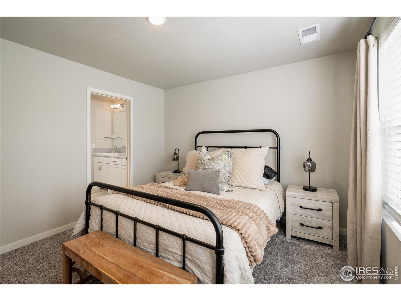 735 South Hoover Avenue Fort Lupton, CO 80621 - Photo 11 of 21 a bedroom with a bed and a window
