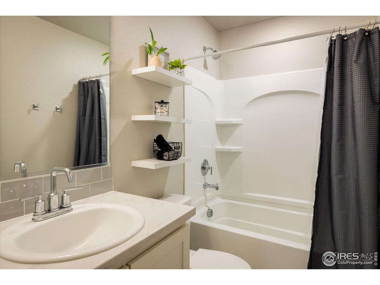 735 South Hoover Avenue Fort Lupton, CO 80621 - Photo 17 of 21 a bathroom with a sink and a mirror