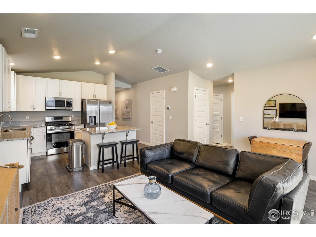 735 South Hoover Avenue Fort Lupton, CO 80621 - Photo 4 of 21 a living room with stainless steel appliances lots of furniture and kitchen view