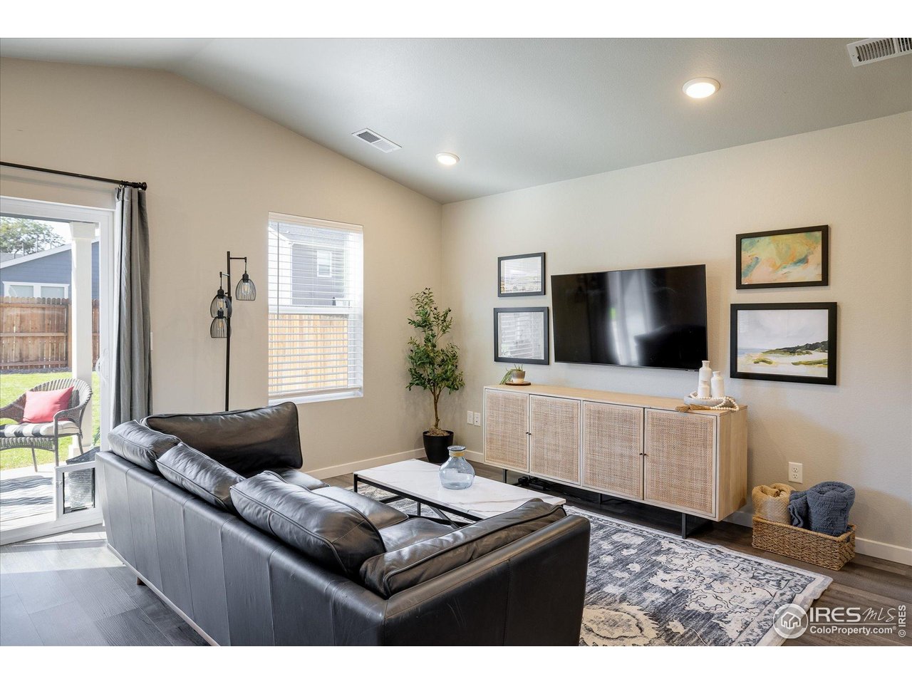 735 South Hoover Avenue Fort Lupton, CO 80621 - Photo 7 of 21 a living room with furniture and a flat screen tv