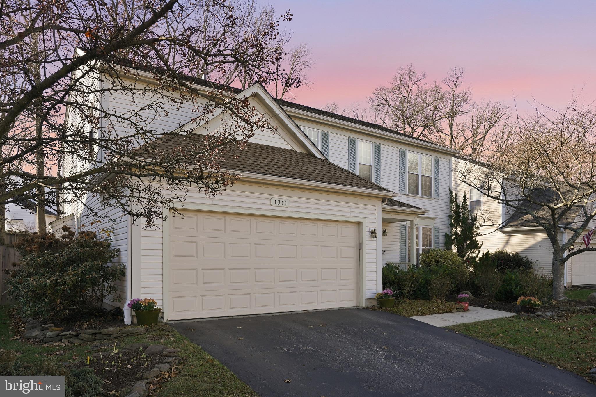 1311 Treasure Drive Odenton, MD 21113 - Photo 2 of 35 a front view of a house with a yard and garage
