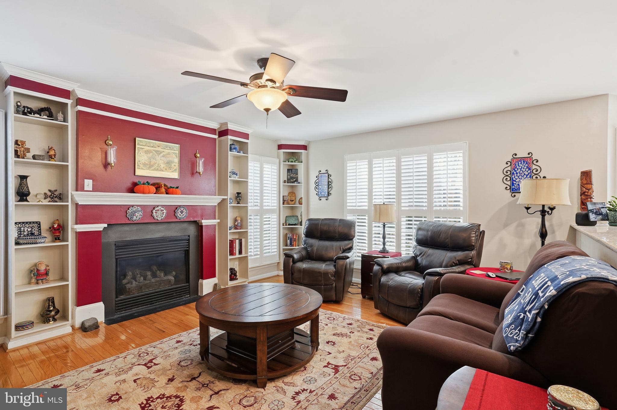 1311 Treasure Drive Odenton, MD 21113 - Photo 3 of 35 a living room with furniture a flat screen tv and a fireplace
