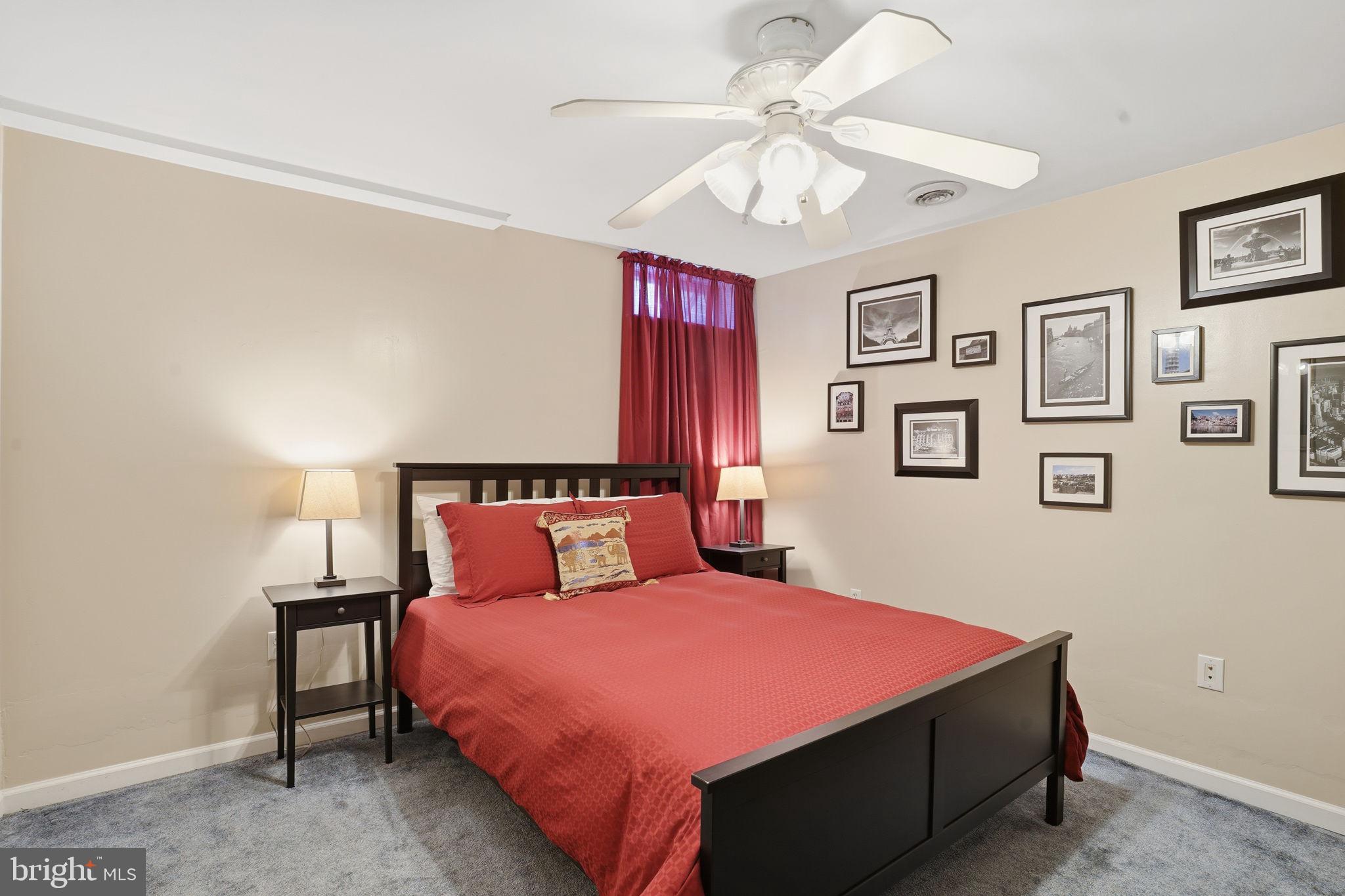 1311 Treasure Drive Odenton, MD 21113 - Photo 31 of 35 a bedroom with a large bed and a chandelier