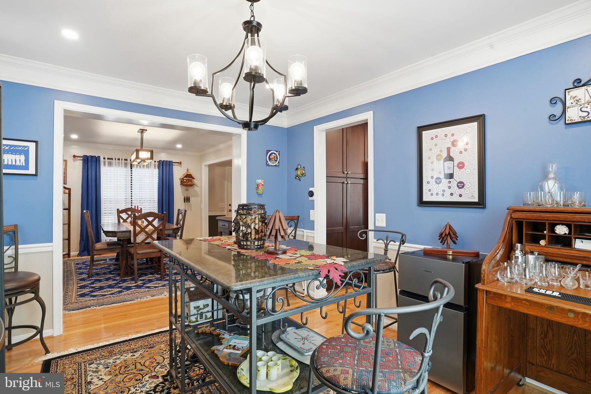 1311 Treasure Drive Odenton, MD 21113 - Photo 8 of 35 a view of a dining room with furniture a chandelier and wooden floor