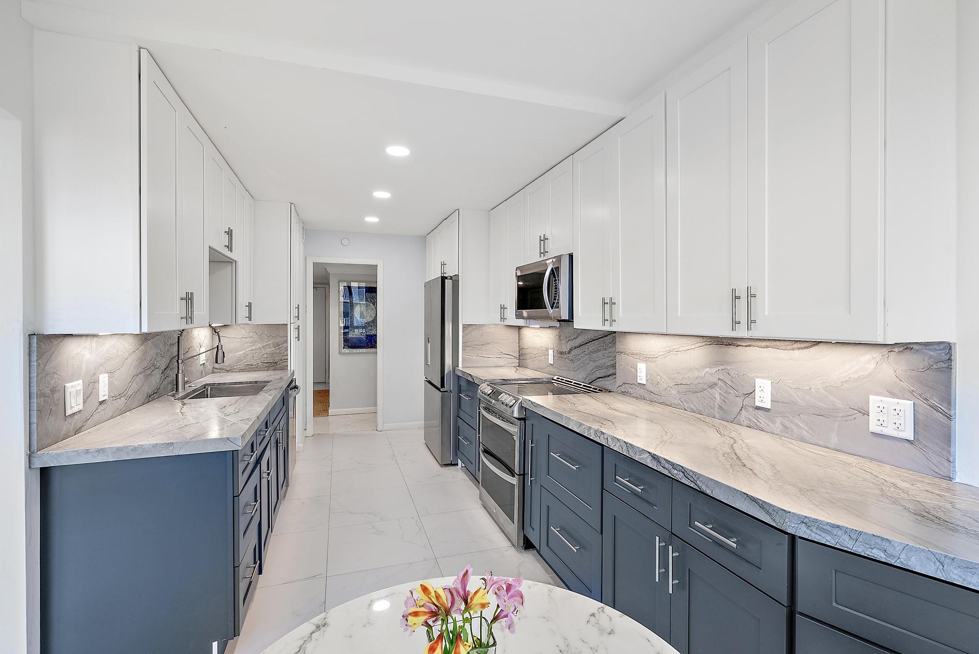 3390 South Ocean Boulevard, Unit 301 Palm Beach, FL 33480 - Photo 17 of 46 a large kitchen with stainless steel appliances granite countertop a sink dishwasher stove and refrigerator