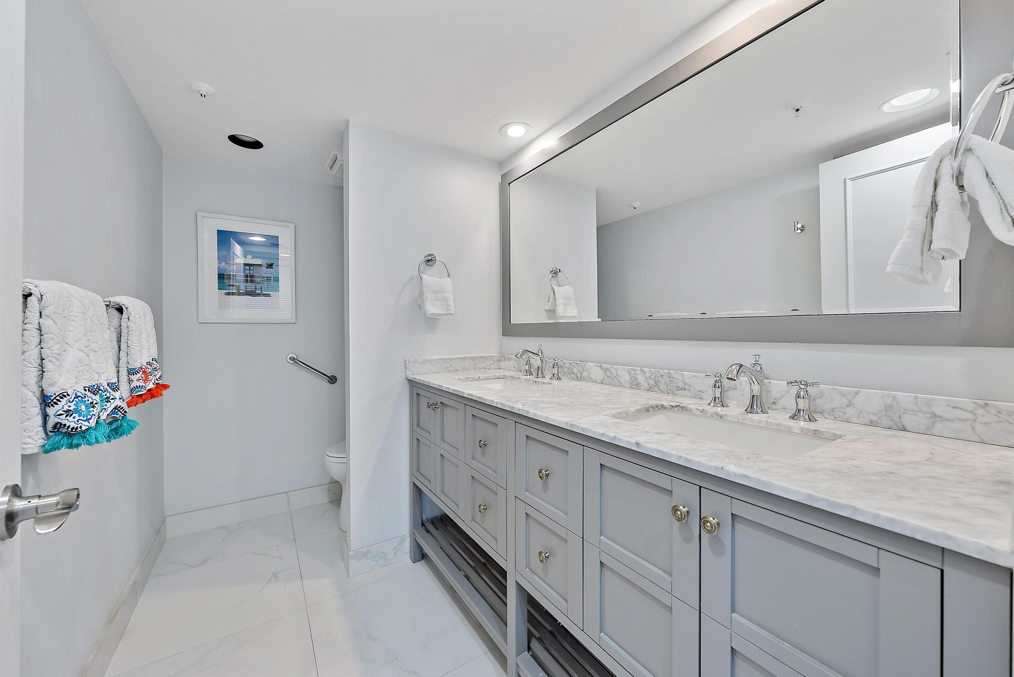 3390 South Ocean Boulevard, Unit 301 Palm Beach, FL 33480 - Photo 21 of 46 a bathroom with a granite countertop sink mirror and vanity