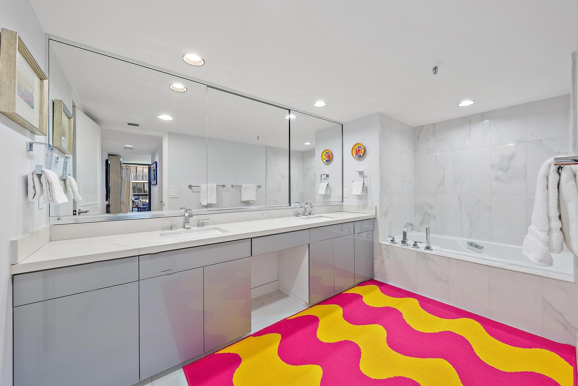 3390 South Ocean Boulevard, Unit 301 Palm Beach, FL 33480 - Photo 25 of 46 a bathroom with a sink mirror and a bathtub