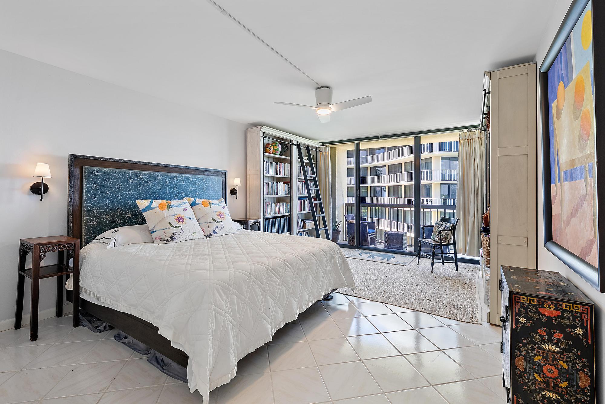 3390 South Ocean Boulevard, Unit 301 Palm Beach, FL 33480 - Photo 26 of 46 a bedroom with a large bed and a large window